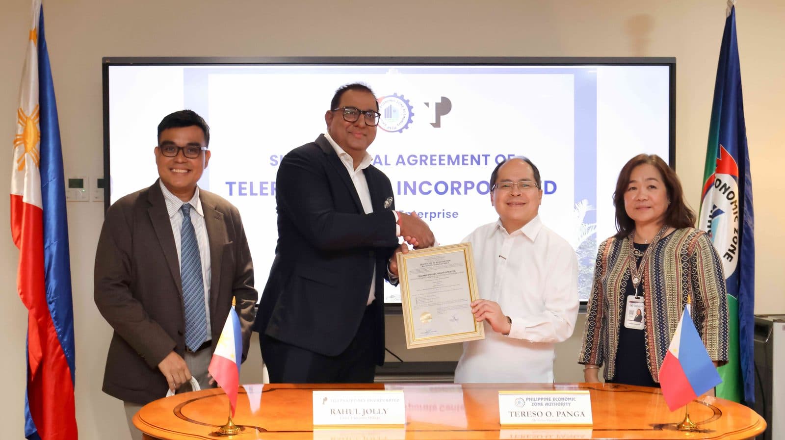 TP in the Philippines CEO Rahul Jolly and PEZA Director General Tereso Panga shaking hands over the signed certificate of registration