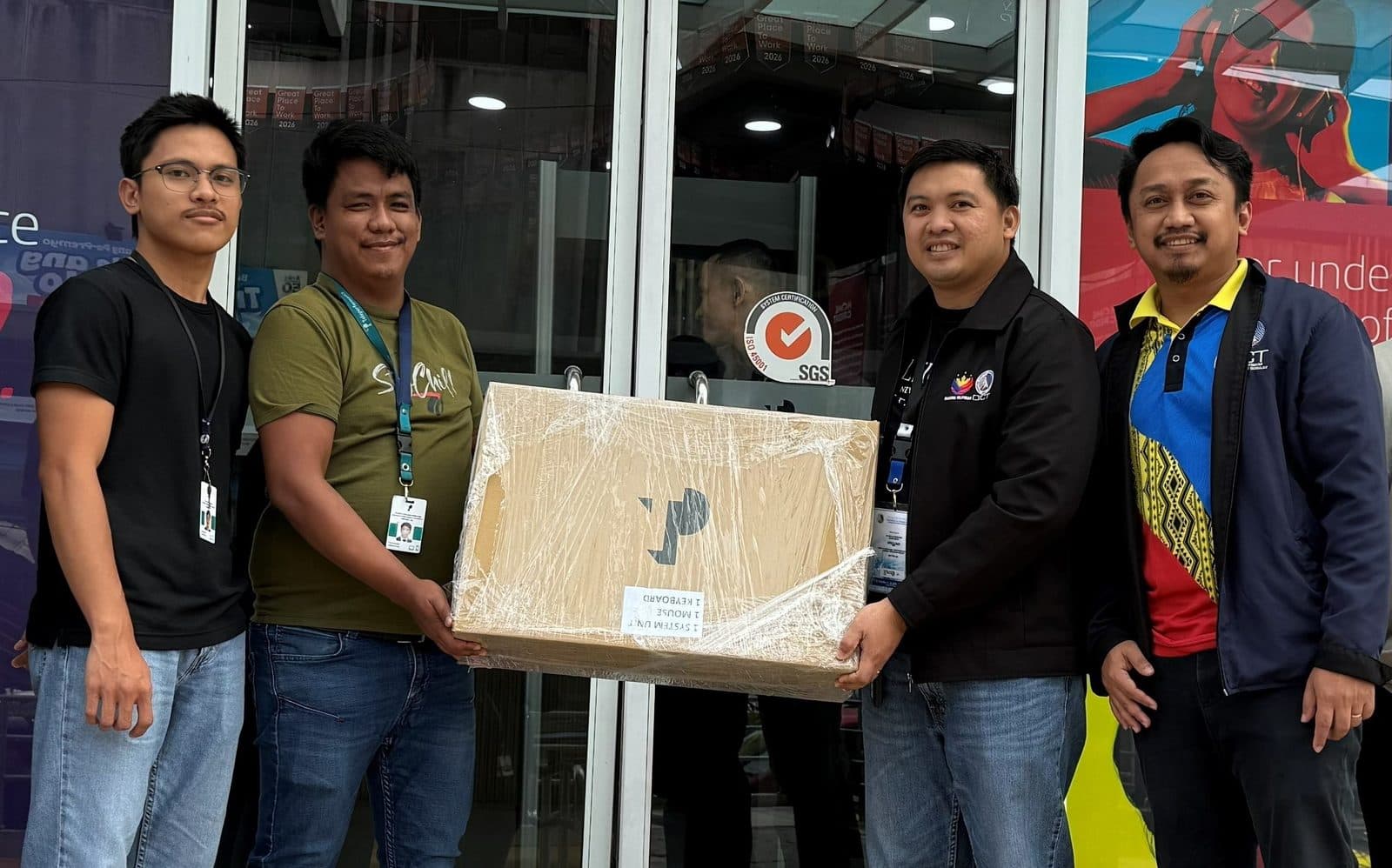 TP desktop engineers handing over a boxed computer unit to DICT Region 10 officials